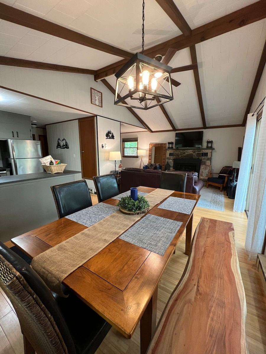 Dining area beneath a vaulted beamed ceiling