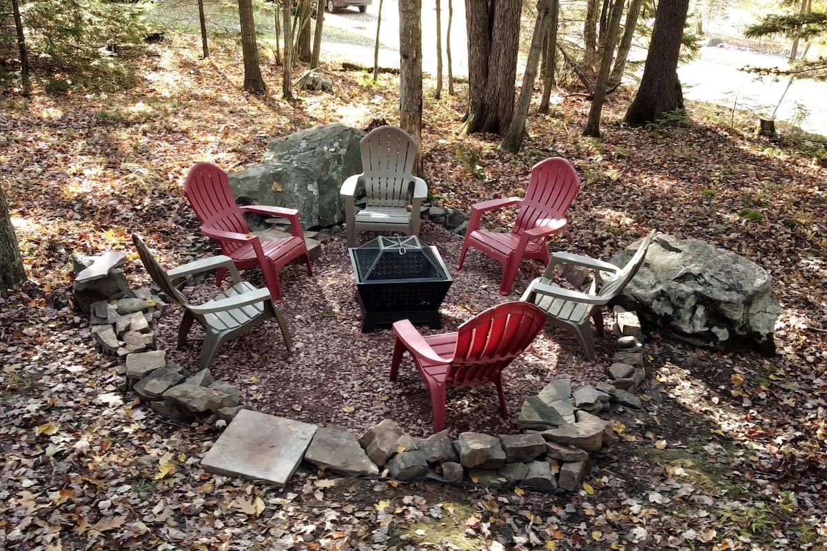The living room at The Plaid Cabin with its stone gas fireplace lit