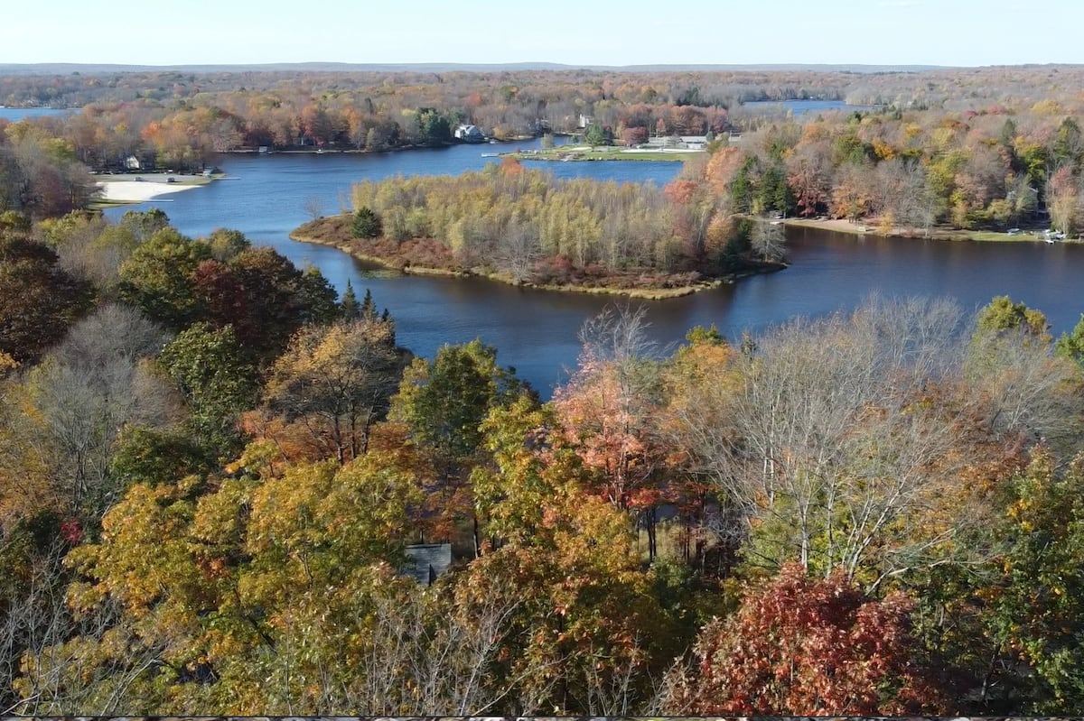Aerial view of Arrowhead Lake surrounded by autumn foliage